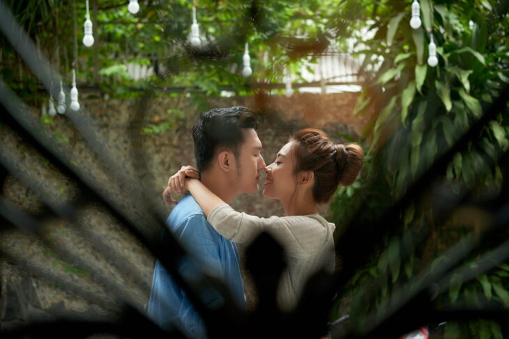 A couple sharing an intimate moment in a garden